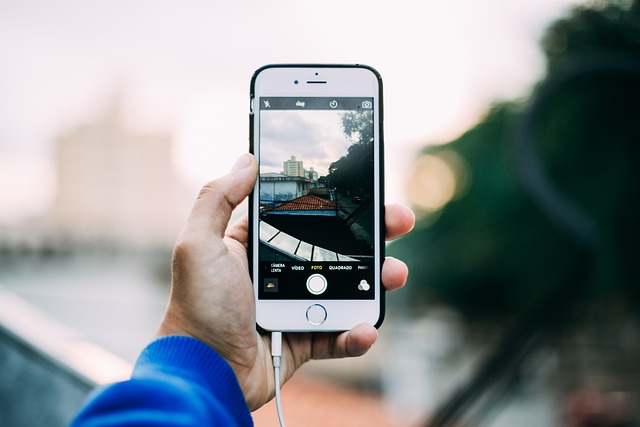 How To Keep An App Open On iPhone 2 Hand holding iPhone with app icons near water