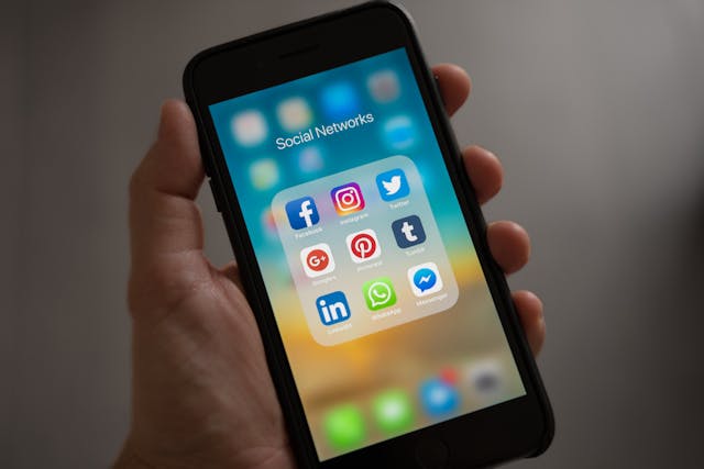 How to Change Facebook Password on iPhone 1 iPhone screen showing Social Networks folder with Facebook, Instagram, Twitter and more apps