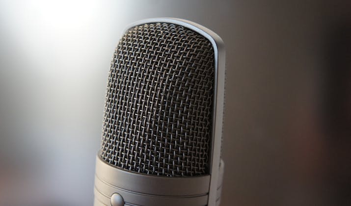 How To Mute Microphone On Mac? 1 Close-up studio microphone with metal mesh grille