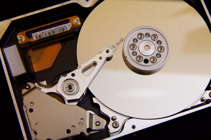 How to Split Your iMac's Fusion Drive 3 Close-up of open computer hard drive platter and read write arm