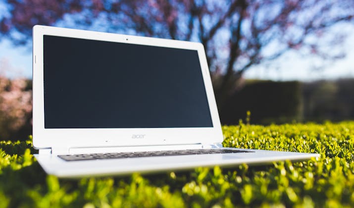How to Remove Chromebook Management ? 3 White Acer laptop placed on green grass outdoors in sunlight
