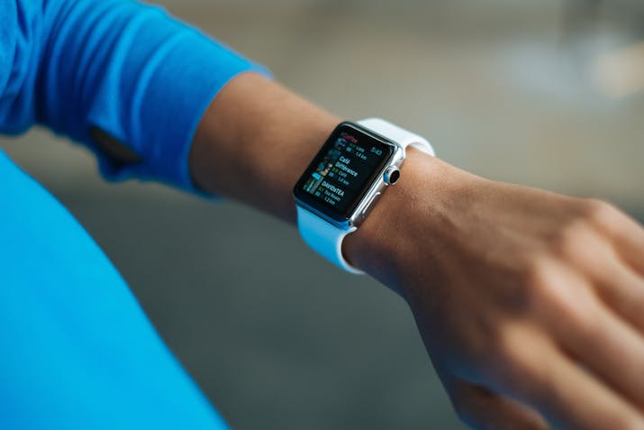 What Does Always On Display Mean for Apple Watch? 2 Apple Watch with white sport band displaying fitness stats and heart-rate data on wrist