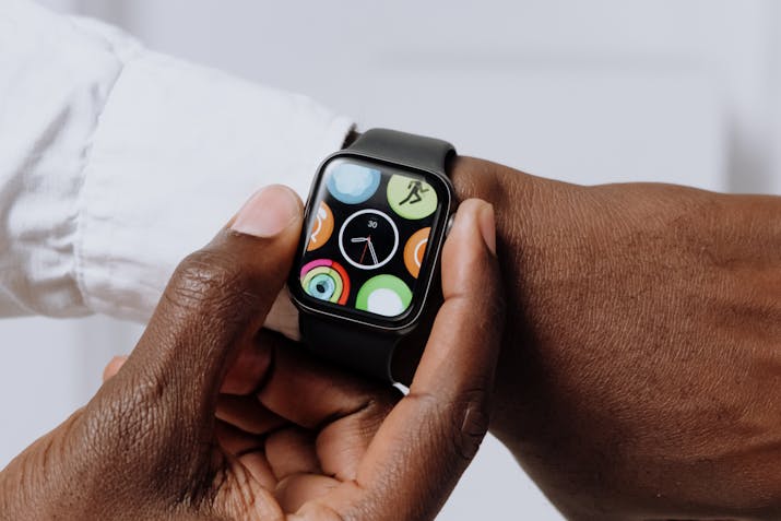 How To Get Voice Memo From Apple Watch To Iphone 2 Person adjusting an Apple Watch showing colorful app icons.