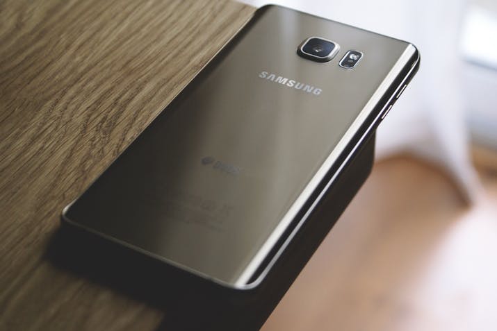 How to Remove OneDrive From Your Samsung Galaxy Note 20 2 Back of a Samsung smartphone on a wooden table, close-up