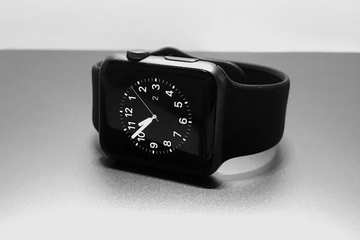 Apple Watch Warranty - Questions Answered 2 Black Apple Watch with analog watch face on desk