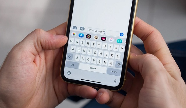 What Does 'Delivered' Status Mean on Your iPhone? 5 Hands holding an iPhone open to Messages, typing “What up man?” in the text field