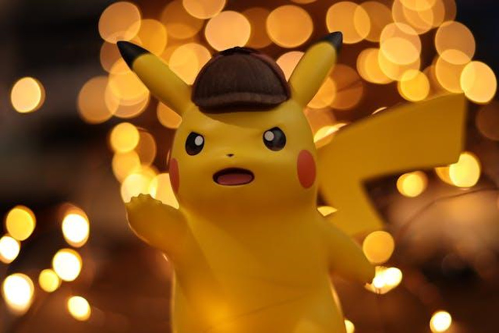 Detective Pikachu figurine with bokeh lights background