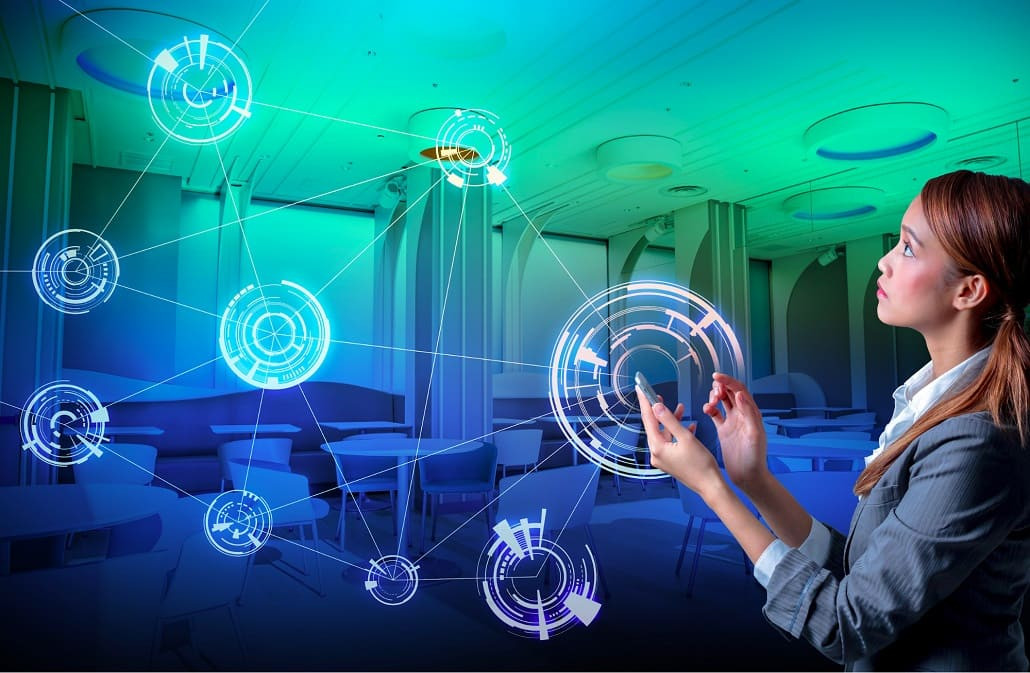 Smart Home Technology: The Definitive Guide 4 A woman using a touch pad device to control her home.